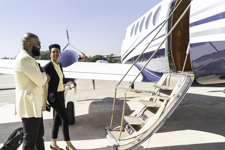jet cars members boarding a flight